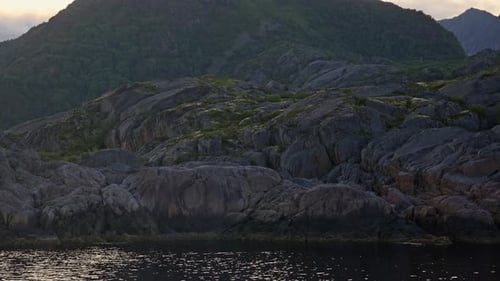 Ferry Traversing Past Rugged Islands