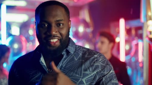 Closeup Afro Man Looking at Camera at Night Club Party. Portrait Of