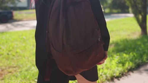 Young Person with Bag Strolling Outside Caucasian Youth Carrying Backpack Outdoors in Park Student