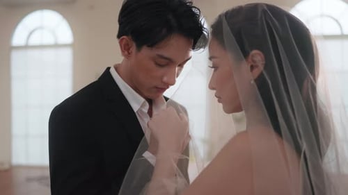 Romantic Groom Kisses Bride's Hand Through Veil