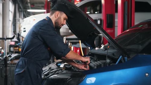 Focused at work. Mechanic is in a car service station.