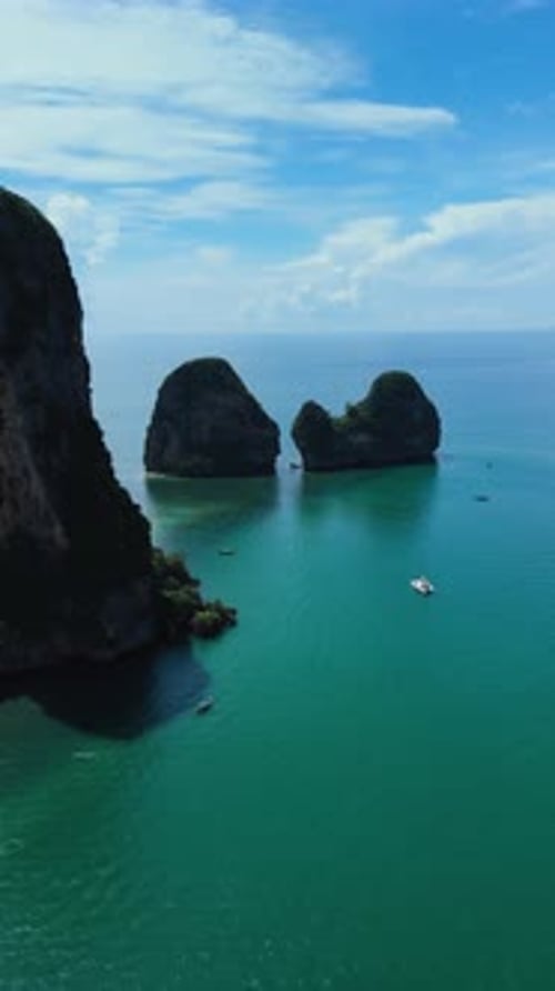 Vertical aerial approach pan left reveal of Phra Nang Beach, Krabi