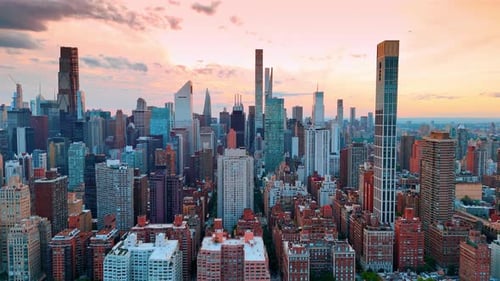 Flight along the scenery of modern Manhattan. Panorama of New York at sunset time.