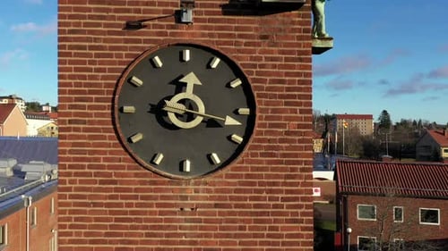 The red clock tower of a fire station in Fagersta, Sweden - focus pull reverse dolly