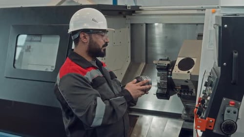 Male Technician Repairing Machine Equipment at Factory