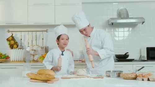 Joyful Baking: Father and Child Sing with Rolling Pins