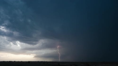 Dramatic Storm Clouds and Lightning over Flat Landscape