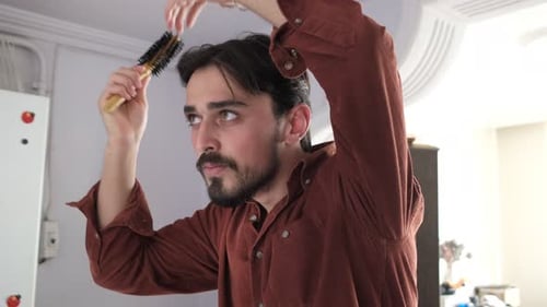 Man Brushing Hair in the Bathroom