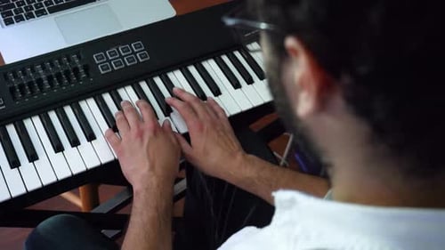 Adult with Keyboard Making Music