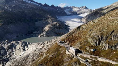 Aerial flyover over Furka mountain pass at the border of Valais and Uri in Switzerland with a view o