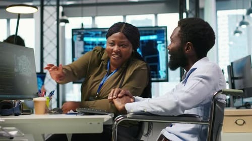 Programador de escritório de startups em cadeira de rodas conversando com colega que desenvolve IA