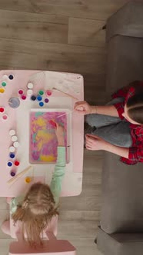 Girl Mixes Paints with Comb Making Ebru Design with Sister
