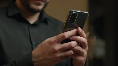 Adult using smartphone indoors