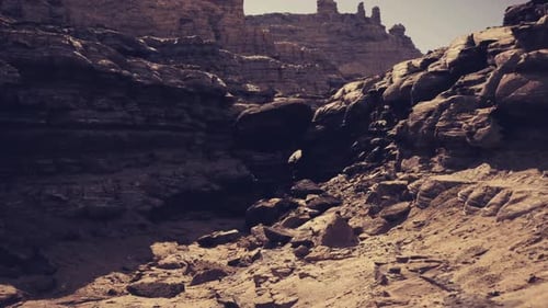 Sunlit Canyon Slope Showcasing Fractured Stones and Active Outdoor Pursuits