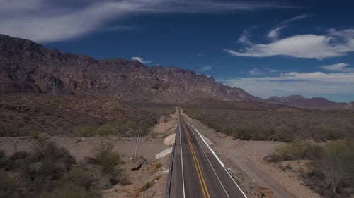Drone View of Desert Asphalt Road with Scenic Rocky Mountain