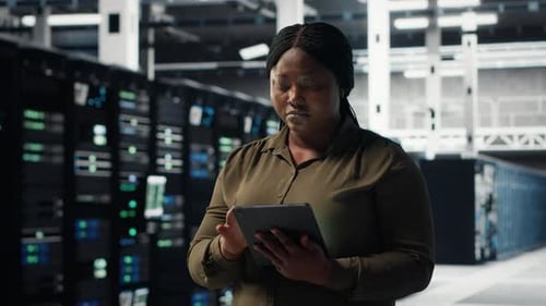Technician Using Tablet in Data Center Integrating New Technologies
