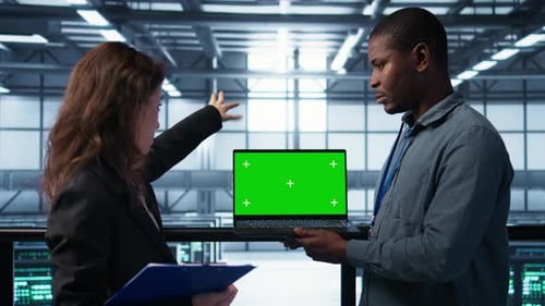 Engineers in Data Center Using Green Screen Laptop Reviewing Equipment Health