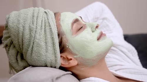 Woman Relaxing at Home Embracing the Serenity of a Facial Moisturizing Mask During Spa Session