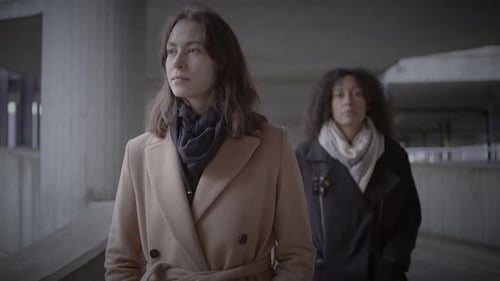 Lifestyle Portrait of Two Young Women Watching Tower Building Together