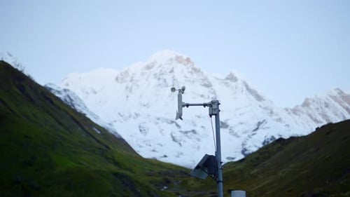 Weather Station with Spinning Anemometer in Rural Mountains
