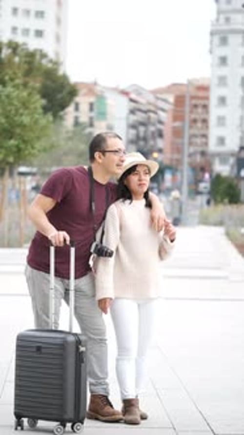 Multiracial Couple of Tourists Exploring the City Together and Pointing