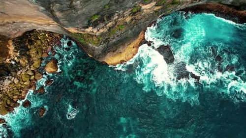 4k Drone Ascends from Waves Crashing against Tall Cliff in Bali, Indonesia