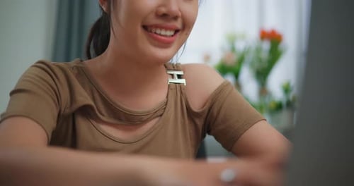Young Adult Woman Using Laptop At Home