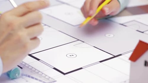 Architects Discussing Blueprint Plans in the Office