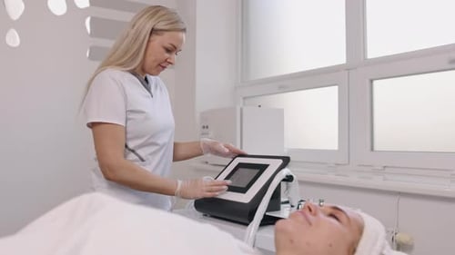 Woman Working with Medical Machine in Treatment Room
