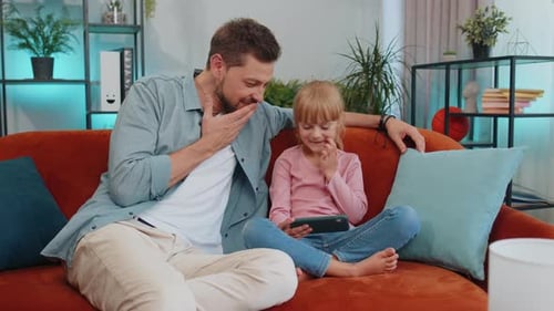 Father and Daughter Enjoying Time Together with Technology