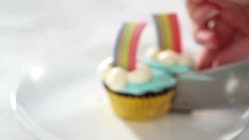 Chocolate Cupcakes Decorated with Blue Buttercream Frosting and Rainbow for Unicorn Theme Birthday