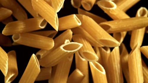 Close up of golden raw penne pasta