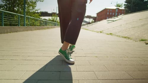 Legs and Feet Dancing on Urban Walkway