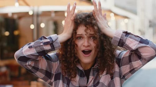 Young Woman Looking Surprised at Camera Shocked By Sudden Win Good Victory News Wow in City Street