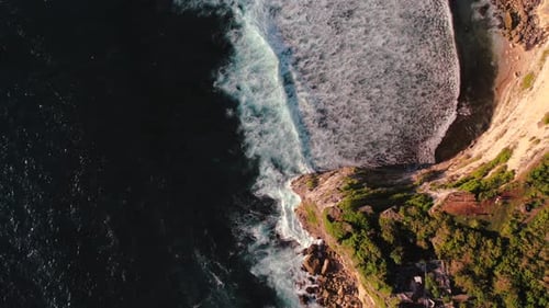 Top Down Video of Waves Crashing in Ocean Near Uluwatu Temple in Bali Indonesia