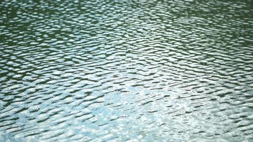 Sun Reflecting on Sparkling Sea Lake Water Surface Ocean at Sunset Sunrise Sunrays Flickering in