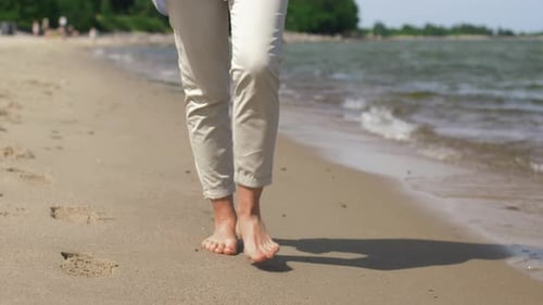 People and Leisure Concept - Woman Feet Walking Barefoot Along Summer Beach Adult