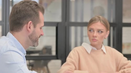 Side View of Man Talking with Colleagues