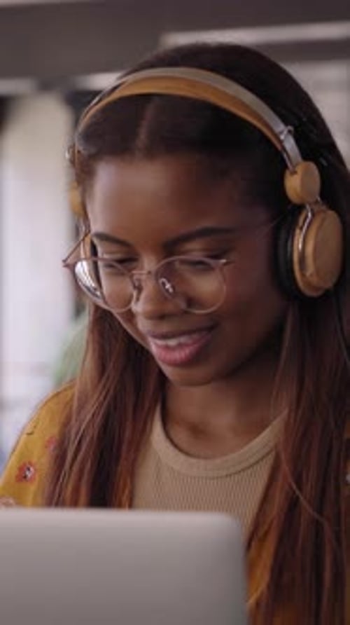 Vertical Young African American College Student Using Laptop with Headphones People at Class Break