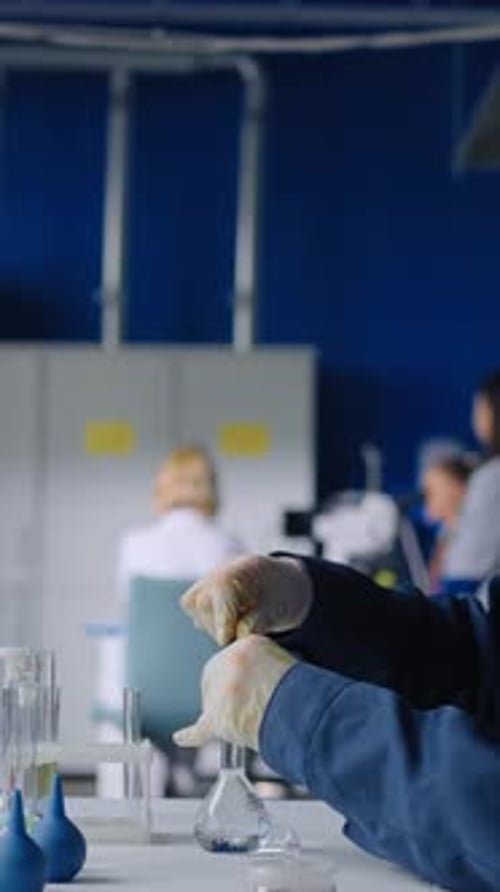 Scientist mixes chemicals in lab for scientific research