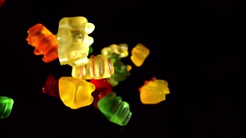 Gummy Bears Candy Falling on Black Background