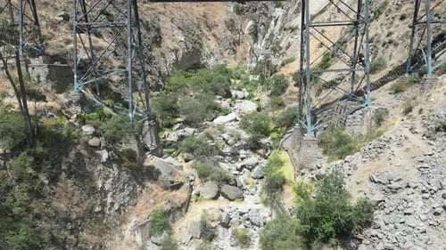 Aerial dolly drone shot through a railroad bridge in the mountains of matacuna lima in peru with vie