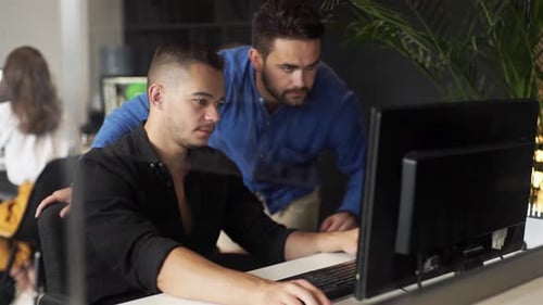 Men Colleagues Discuss Online Project Look at Pc Screen Mentor Teaches Young Man Explains Corporate