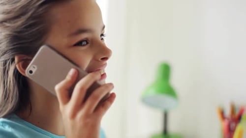 Smiling Girl Chatting on Mobile Phone Indoors