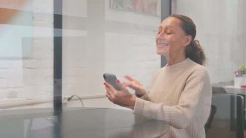 Woman Waving and Smiling During Video Conference