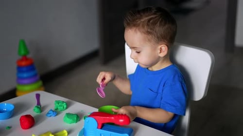 Young Child Playing with Clay at Home
