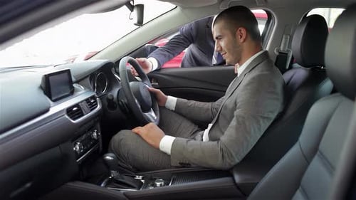 Confident Young Man Enjoying a Test Drive in a Sleek Car