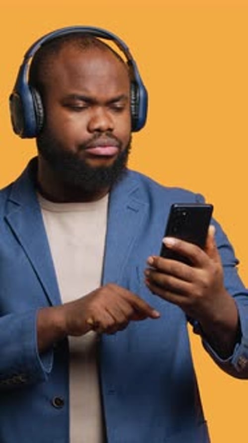 Vertical Video Relaxed Person Selecting Songs From Playlist Studio Background