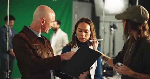 Makeup, director and beautician with model in studio for photoshoot, filming or production