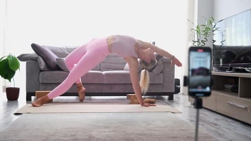 Woman Practices Yoga Poses in Home Studio
